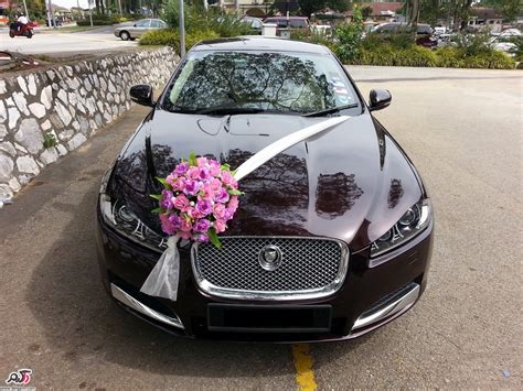 a black car with a bouquet of flowers on the hood