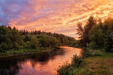 Bright dramatic sunset over river with forest along riverside 1158030 ...