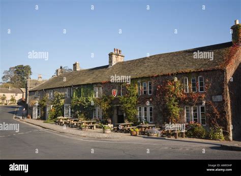 Red Lion and Manor House Hotel front with outdoor tables in Yorkshire Dales National Park ...