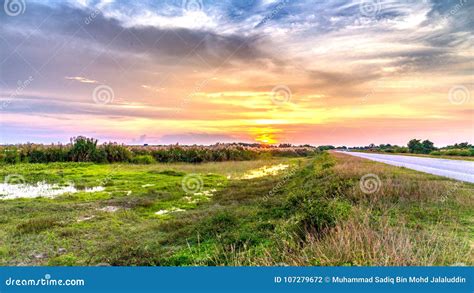 A Sunset View with the Scenic Green Landscape at Highway Road Stock Photo - Image of sunset ...