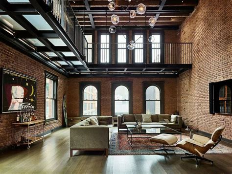 Living Area With Lots Of Exposed Brick Sits Beneath A Metal Catwalk In ...