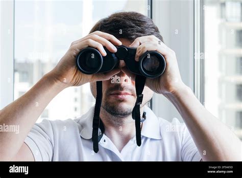 Man binoculars spying hi-res stock photography and images - Alamy