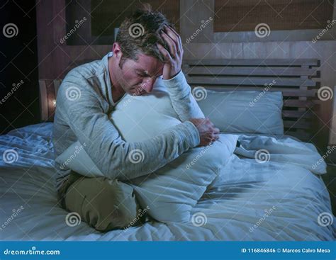 Young Sad and Desperate Man Awake Late Night on Bed in Darkness Suffering Depression and Anxiety ...