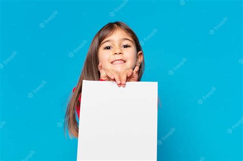 Premium Photo | Pretty little girl happy expression an a sheet of paper