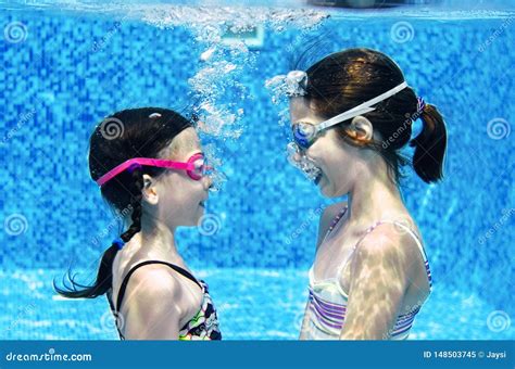 Children Swim in Swimming Pool Underwater, Happy Active Girls Have Fun ...