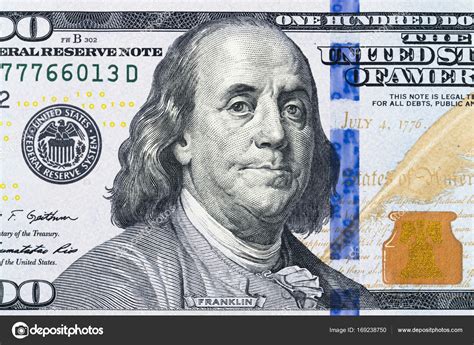 Close up overhead view of Benjamin Franklin face on 100 US dollar bill ...