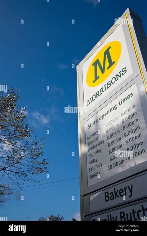 Morrison's supermarket sign showing opening times Stock Photo - Alamy