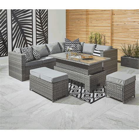 an outdoor living room with grey wicker furniture