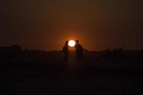 Silhouette of two people in front of the sunset 2029297 Stock Photo at ...