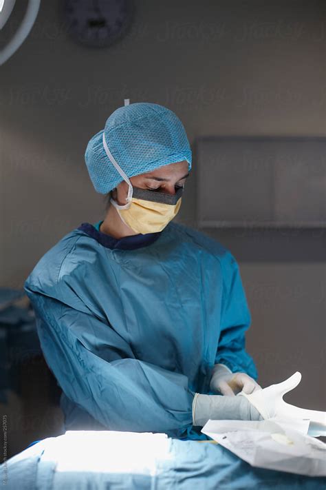 "Female Surgeon Putting On Surgical Gloves" by Stocksy Contributor ...