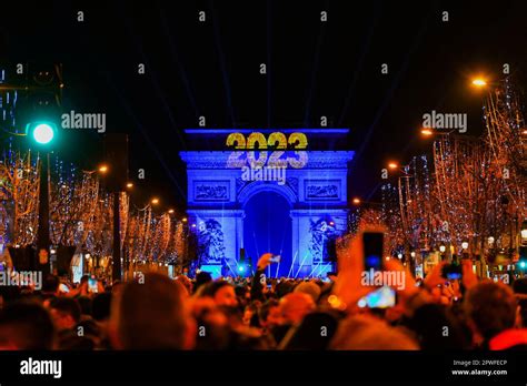 Paris, France - January 1st, 2023 : Crowd gathered on the Champs ...