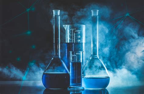 Premium Photo | Test tube and flask with blue liquid and blue smoke ...