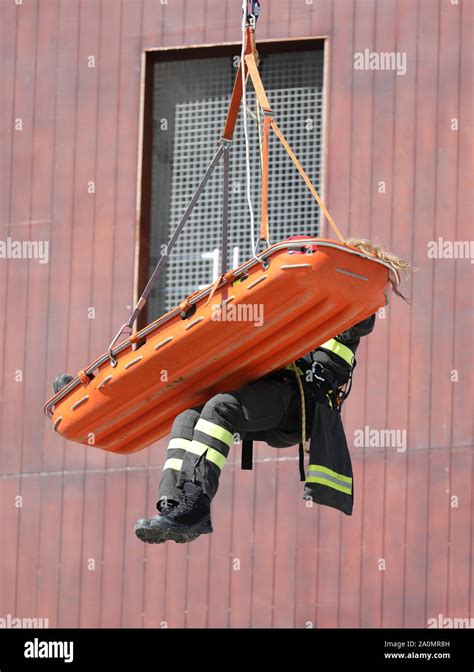 special stretcher for the rescue of the injured is lowered with the rope from a high skyscraper ...