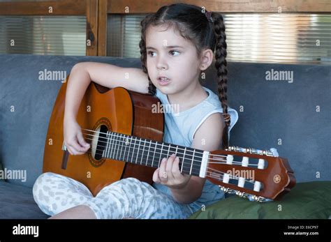 Child playing guitar Stock Photo - Alamy