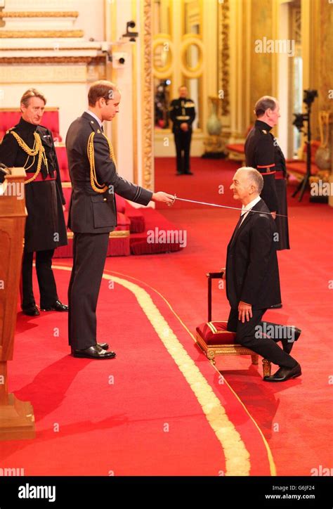 Sir Tony Robinson is knighted by the Duke of Cambridge during an investiture ceremony at ...