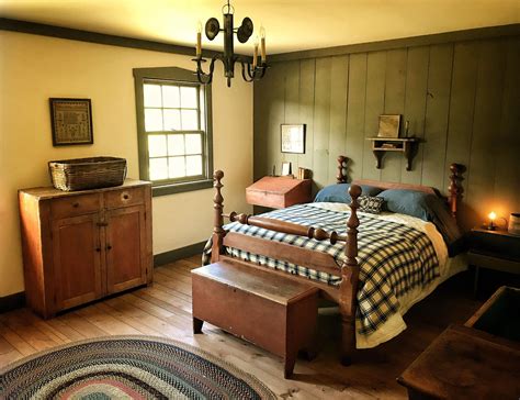 Early Bedroom. Painted trim and accent wall, sampler, braided rug, wood floor, little candle # ...