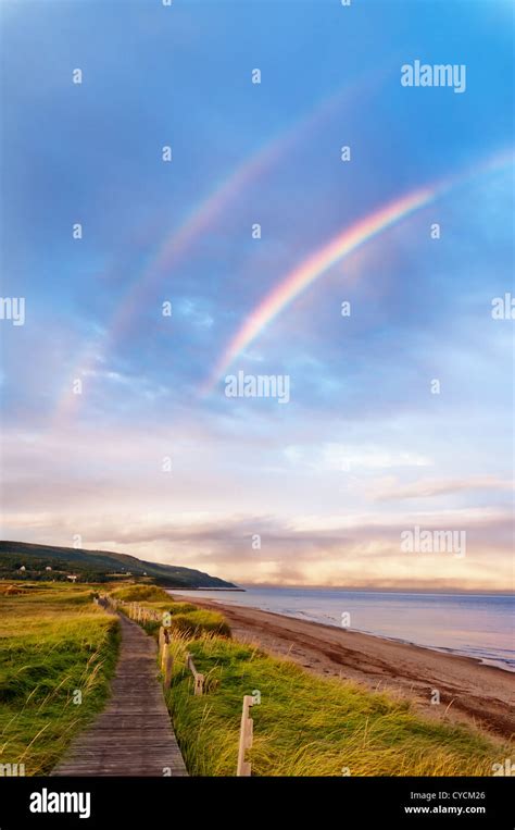 Sunrise at a beach with double rainbow early in the morning Stock Photo ...