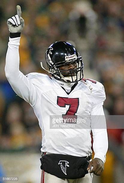 Quarterback Michael Vick of the Atlanta Falcons celebrates after his first touchdown pass ...