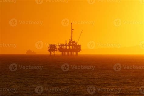 Beach Oil Rig at Sunset 1138443 Stock Photo at Vecteezy