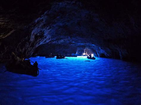 Float through the Blue Grotto, a sea cave in Capri with stunning blue light reflected off of the ...