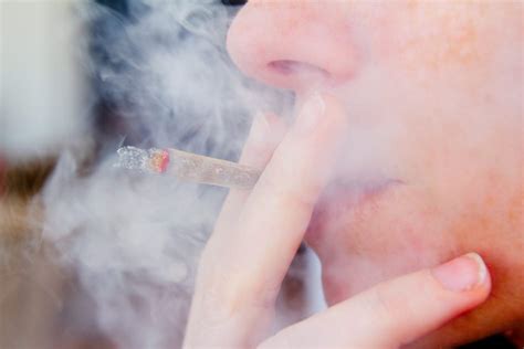 smoking joint closeup with smoke