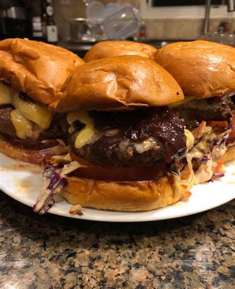 Ground chuck burgers, wine braised sweet onion, sliced tomatoes, slaw with thousand islands ...