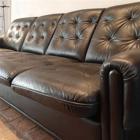 Vintage four-seater sofa made of black leather - Piet Jonker