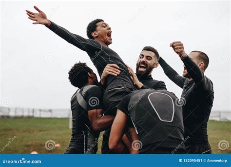 Football Players Lifting Up Their Teammate and Celebrating Stock Image - Image of football, team ...