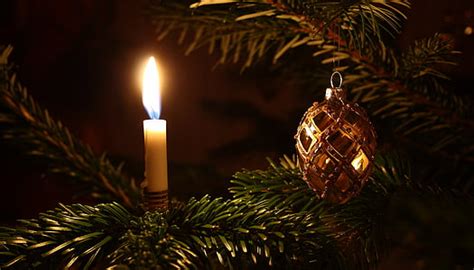 Royalty-Free photo: Shallow focus photography of lamp post with red ribbon and green garland ...