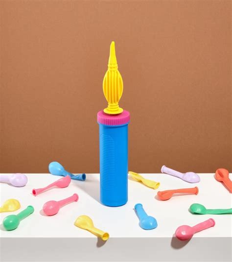 Premium Photo | A blue yellow balloon air pump stands on a table many ...