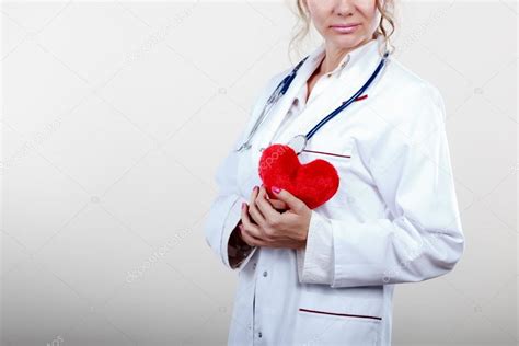 Female cardiologist with red heart. Stock Photo by ©Voyagerix 112650642