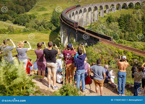 Glenfinnan Viaduct, Scotland, UK - 26 July, 2019: Crowds of Tourists Photographing Glenfinnan ...