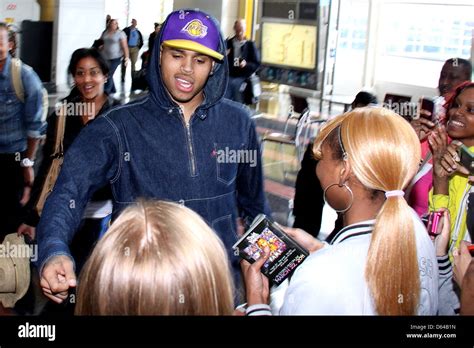 Chris Brown with fans after arriving at Ronald Reagan National Airport to promote his new album ...