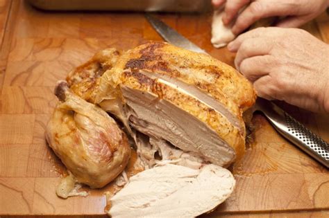 Whole roast chicken sliced through the breast - Free Stock Image