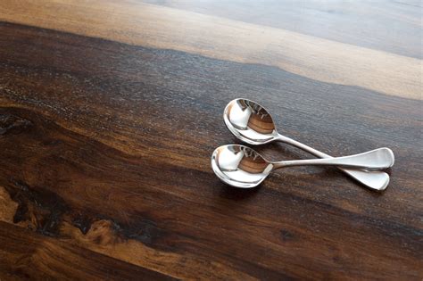 Two silver soup spoons on wood with copy space - Free Stock Image