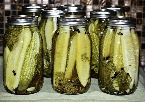 several jars filled with pickles sitting on top of a table