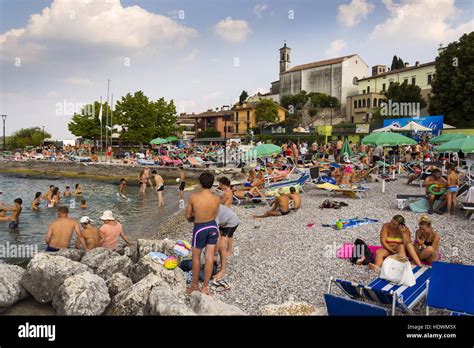 People sunbathing on beach in Desenzano del Garda, Italy Stock Photo - Alamy