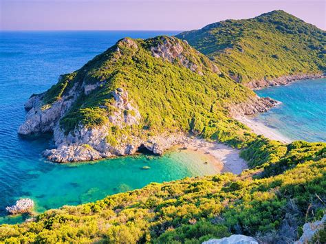 Corfu’s Agios Georgios beach at sunset © Elena Pavlovich / Shutterstock | Greece vacation ...