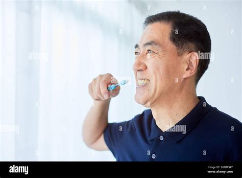 Japanese senior man brushing teeth Stock Photo - Alamy