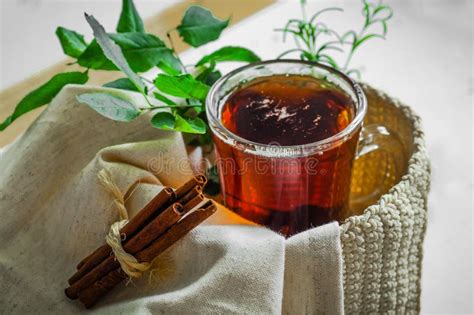 Transparent Cup of Tea Brewed with Adjacent Wooden Spoons. Cinnamon Sticks. Tea Time. Tea Leafs ...