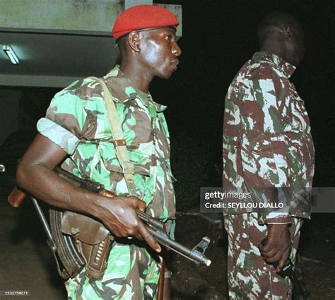 Guinea Bissau's government soldiers stand guard in front of the... News ...