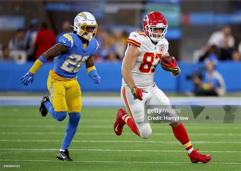 Travis Kelce of the Kansas City Chiefs runs after his catch in front ...