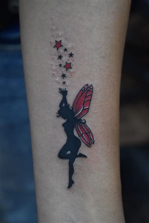 a woman's leg with a tattoo on it that has a butterfly and stars