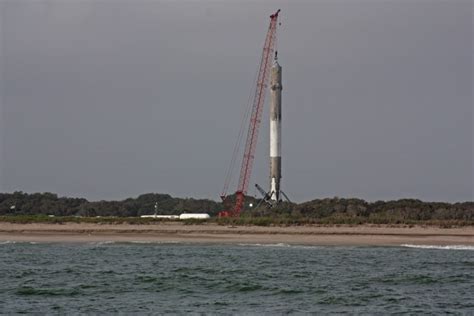 Photos: Falcon 9 booster stands upright after landing – Spaceflight Now