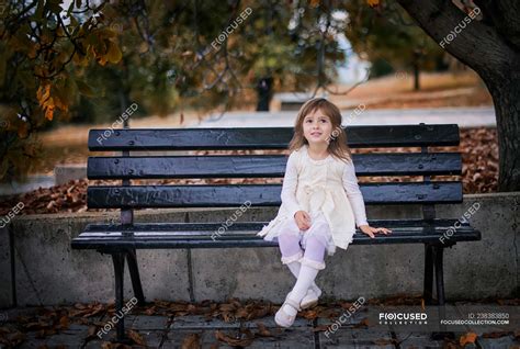 Girl sitting on a bench in the park, Bulgaria — autumn, preschooler ...