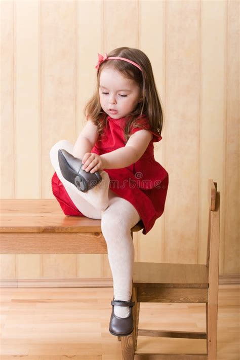 Girl Sitting on Table and Put on One S Shoes Stock Photo - Image of ...