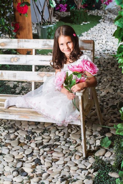 Little Girl Sitting in the Flowered Garden Stock Photo - Image of blossom, female: 52152912