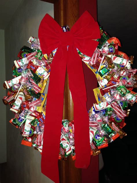 a wreath made out of candy is hanging on the door