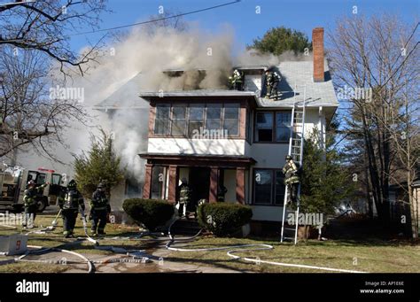 Firefighters fighting a fire House fire Stock Photo - Alamy