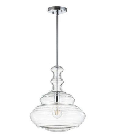 a glass light fixture hanging from the ceiling